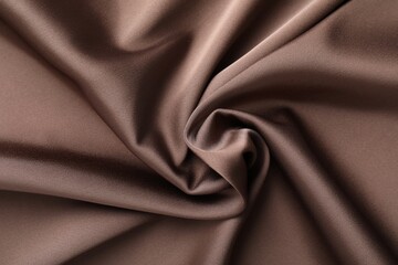 Fototapeta premium Crumpled light brown silk fabric as background, top view