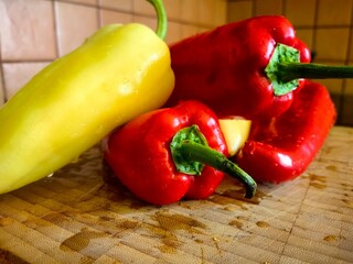 Colorful red and yellow paprika on the kitchen board