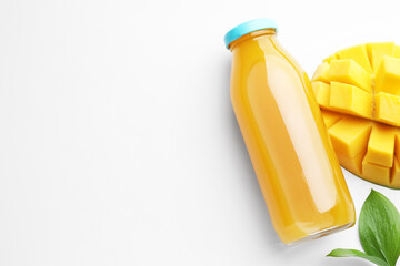 Tasty mango juice in glass bottle, fresh fruit and leaves on white background, flat lay. Space for...