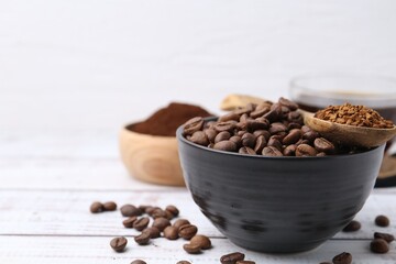 Roasted beans and granulated instant coffee on white wooden table, closeup. Space for text