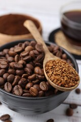 Roasted beans and granulated instant coffee on white wooden table, closeup