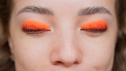 Caucasian woman undergoing eyelash lamination procedure. top view. 