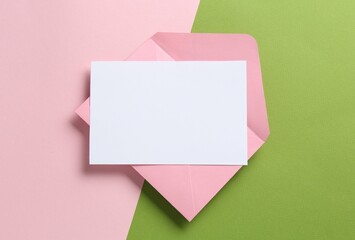 Blank invitation card and envelope on color background, top view. Space for design