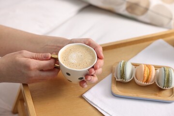 Woman having delicious breakfast in bed, closeup