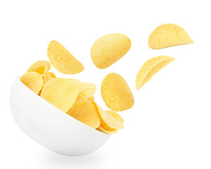 Tasty crispy potato chips falling into bowl on white background
