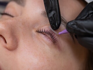 The process of professional eyelash lamination in a salon. 