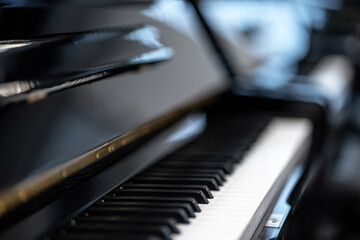 Polished black piano keyboard gently reflecting light © HNstock