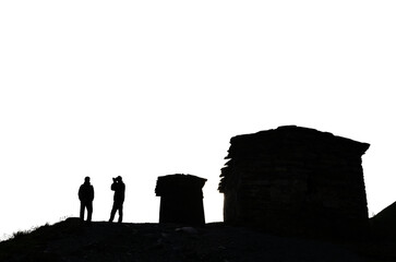 silhouettes of ancient stone towers and silhouettes of people against the sky historical architecture of the Caucasus transparent background