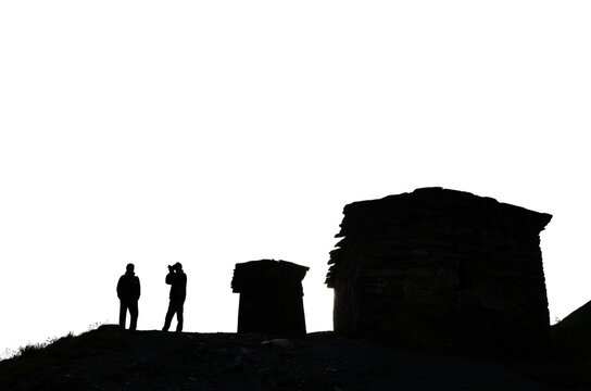 silhouettes of ancient stone towers and silhouettes of people against the sky historical architecture of the Caucasus transparent background
