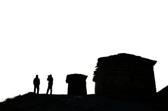 silhouettes of ancient stone towers and silhouettes of people against the sky historical architecture of the Caucasus transparent background