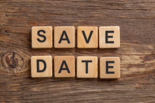 Wooden blocks spelling save the date on rustic wood background