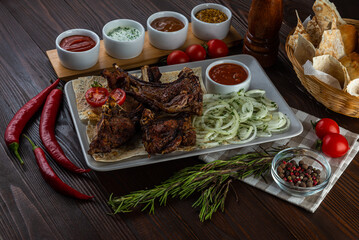 Shashlik with sauces and fresh bread on wooden background