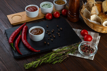 Sweet and sour sauce on wooden background