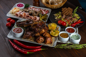 Meat set, salad, bacon on wooden background