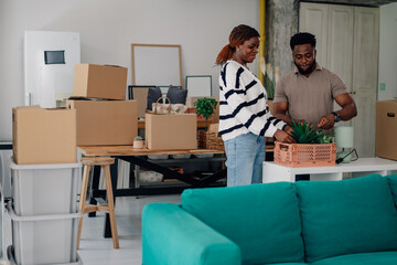 Couple unpacking plants in new home during move