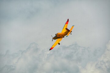 Yellow agricultural plane flies in the sky. small aviation, light aircraft