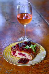 Piece of homemade cherry pie and a glass of white wine