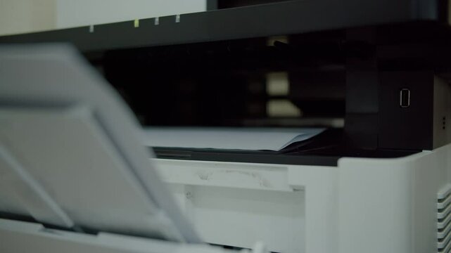 Printed paper coming out of multifunction printer