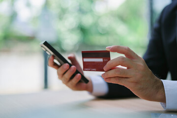 Man using paying through credit card while online shopping on laptop in office