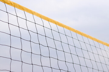 Beach volleyball net close-up. Volleyball net fragment on the beach against the sky. Sport, beach...