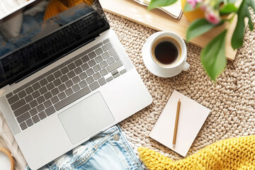 Flat lay mockup of blue denim and woven background with laptop, coffee cup, and notebooks