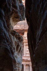 Ancient City View Through Canyon: A glimpse through a narrow canyon reveals an ancient city, a testament to human ingenuity and cultural heritage, evoking a sense of wonder and adventure.