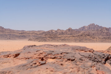 Desert Landscape: A breathtaking vista of the vast desert landscape, the rough-hewn terrain and textured foreground details the earth's raw beauty and strength.