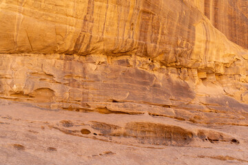 Textured Desert Cliff: A stunning close-up of a desert cliff face, showcasing intricate rock formations, unique patterns, and the warm, sun-kissed hues of the arid landscape.