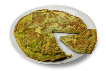 Green omelet made with eggs and wild and aromatic herbs isolated on white with clipping path included