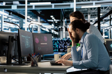 Server room colleagues cooperate to eliminate threats using artificial intelligence tools. Data...