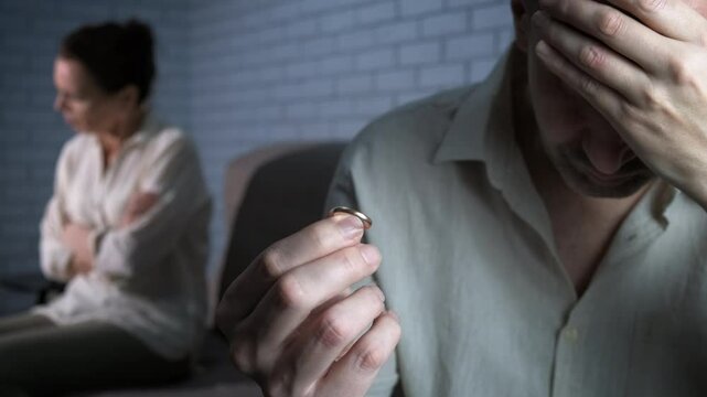 Problem of mistrust at divorce. A man feel mistrust to his wife and takes off his golden ring by the upset female