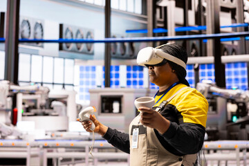 Factory worker wearing VR headset and holding motion controllers engages in virtual reality training in advanced industrial plant. Female engineer highlighting the role of AR in modern manufacturing.