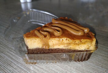 A slice of chocoflan, also known as impossible cake, featuring a layer of flan over chocolate sponge cake, topped with thick swirls of dulce de leche.