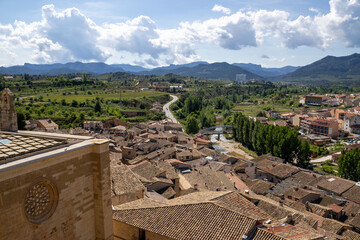 Historic Santa María la Mayor Church framed by medieval castle walls in Valderrobres, Teruel, with...
