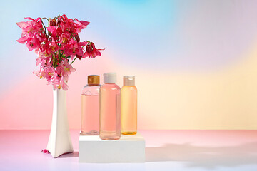 Wellness composition with rose water and fresh columbine and aquilegia flowers, spa salon advertising card, natural self-care and healthy lifestyle concept, abstract composition with flowers.