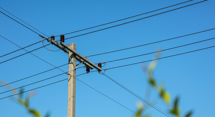 high voltage power lines on blue sky background