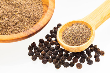 Piper nigrum - Flavored black pepper powder in a spoon and bowl