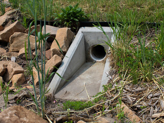 a precast concrete headwall installed for drainage. a structural component used for management systems. a stable transition between pipes or culverts. erosion control design element