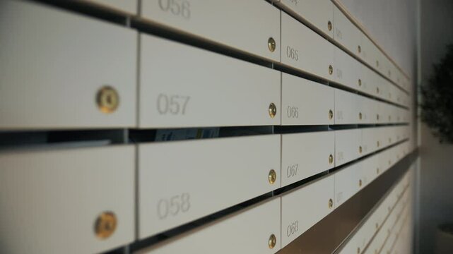 Row of numbered apartment mailboxes with keyholes