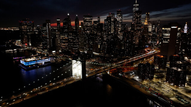 Night Scape Of Brooklyn Bridge At Manhattan In New York United States. City At Night Scene. Illuminated Bridge Landscape. Brooklyn Bridge At New York United States. Highrise Buildings. 