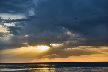 Professional woman in business attire confidently discussing strategies against a city skyline backdrop at sunset, showcasing empowerment and ambition.