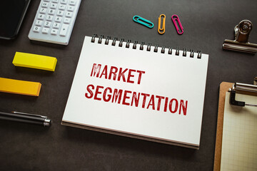 There is notebook with the word Market segmentation. It is as an eye-catching image.