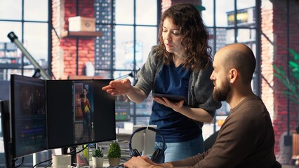 Man and woman collaborate on content creation for the media industry, analyzing data and insights, editing video footage and adjusting branding elements. AI powered. Camera B.