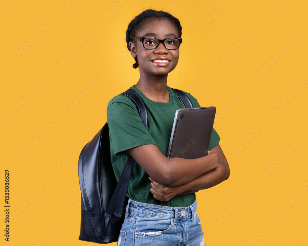 Aufkleber smiling african female student holding laptop hugging computer posing standing on yellow studio back