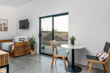 Modern desert living room interior concrete floors, sofa, dining set