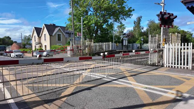 Wrenbury Cheshire East England UK. 07.06.2025. Video. Wrenbury station in the village of Wrenbury Cheshire England UK with level crossing barriers down and closed to traffic.