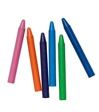 Wax crayons in different bright colors scattered on transparent background representing childhood creativity and artistic tools