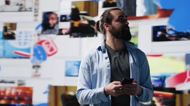 Modern online lifestyle of a young man checking real time notifications, enjoying interaction with followers and posting creative content in a social network environment. Camera A.
