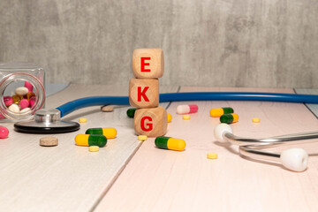 A coloured wooden cubes with text EKG. EKG stands for Electrocardiogram.