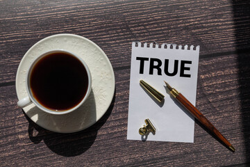 A neon sign with the word "true" on a grunge background